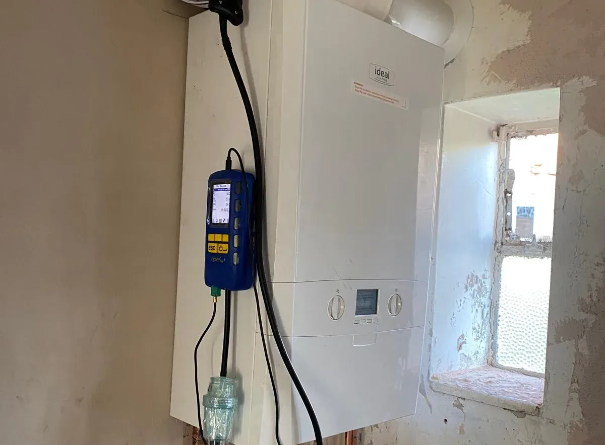 Gas Safe registered engineer taking a working pressure reading on a boiler during a landlord gas safety inspection in Bromley
