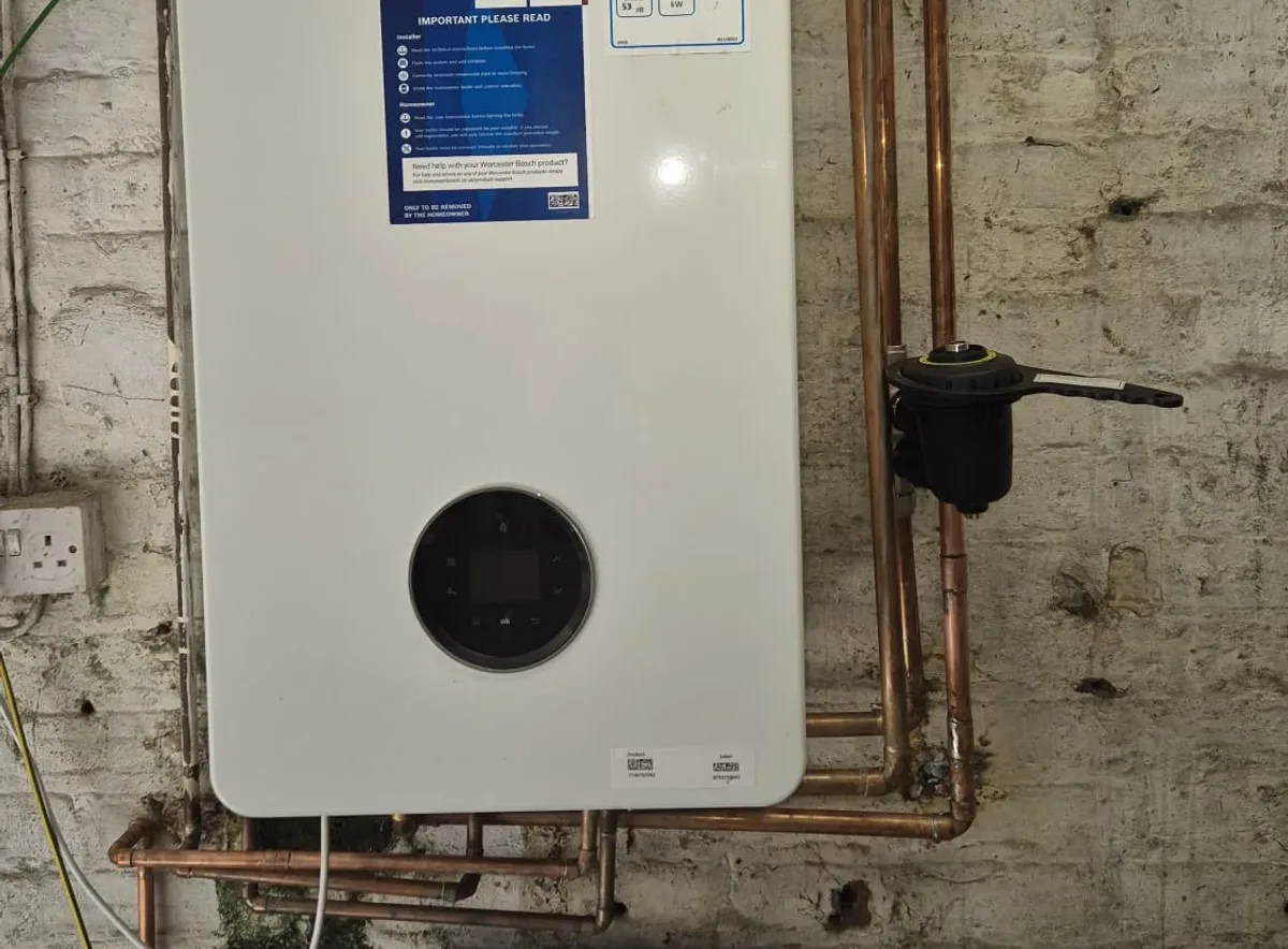 A newly installed Worcester Bosch combi boiler with a magnetic system filter and neat copper pipework