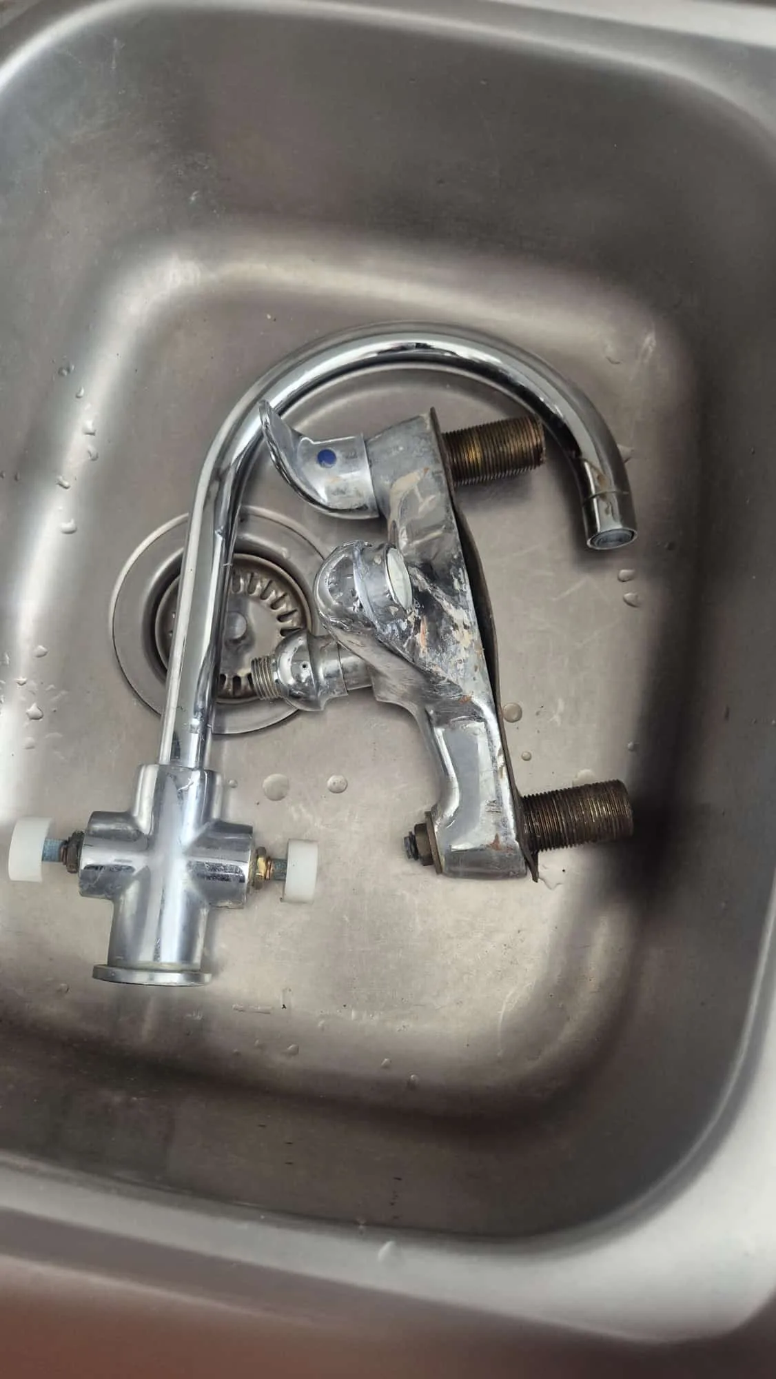 Separate job the same evening — old kitchen mixer removed, showing the worn body and corroded back-nut threads.